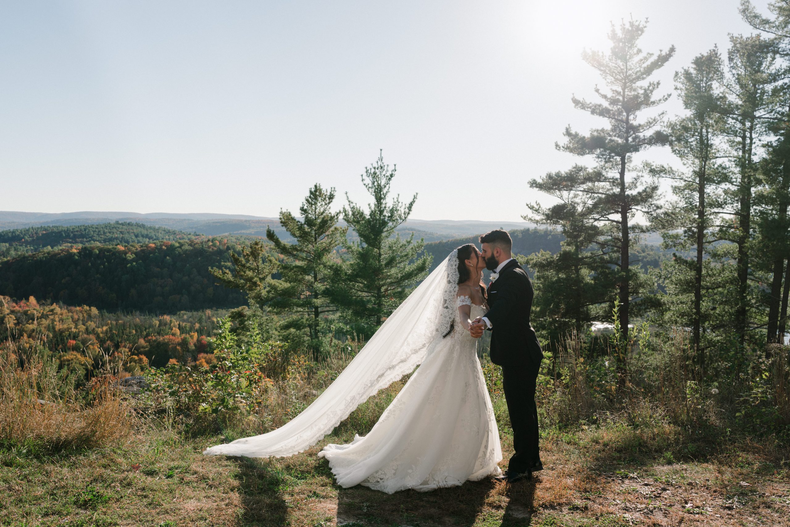 Bride and groom kissing at the view in Quebec
