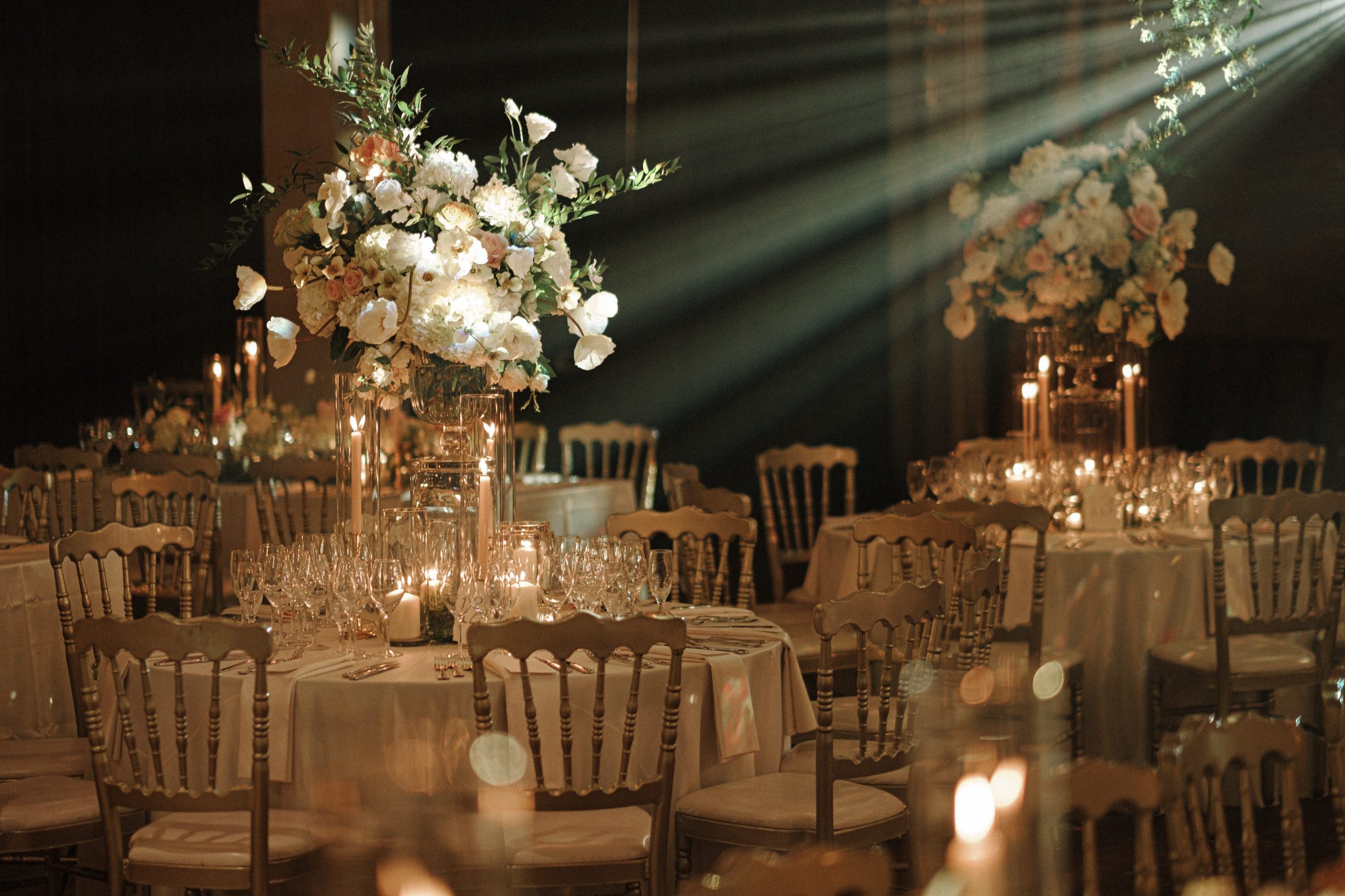 reception details with luscious florals and spotlights