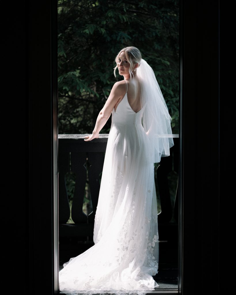 bride looks off balcony