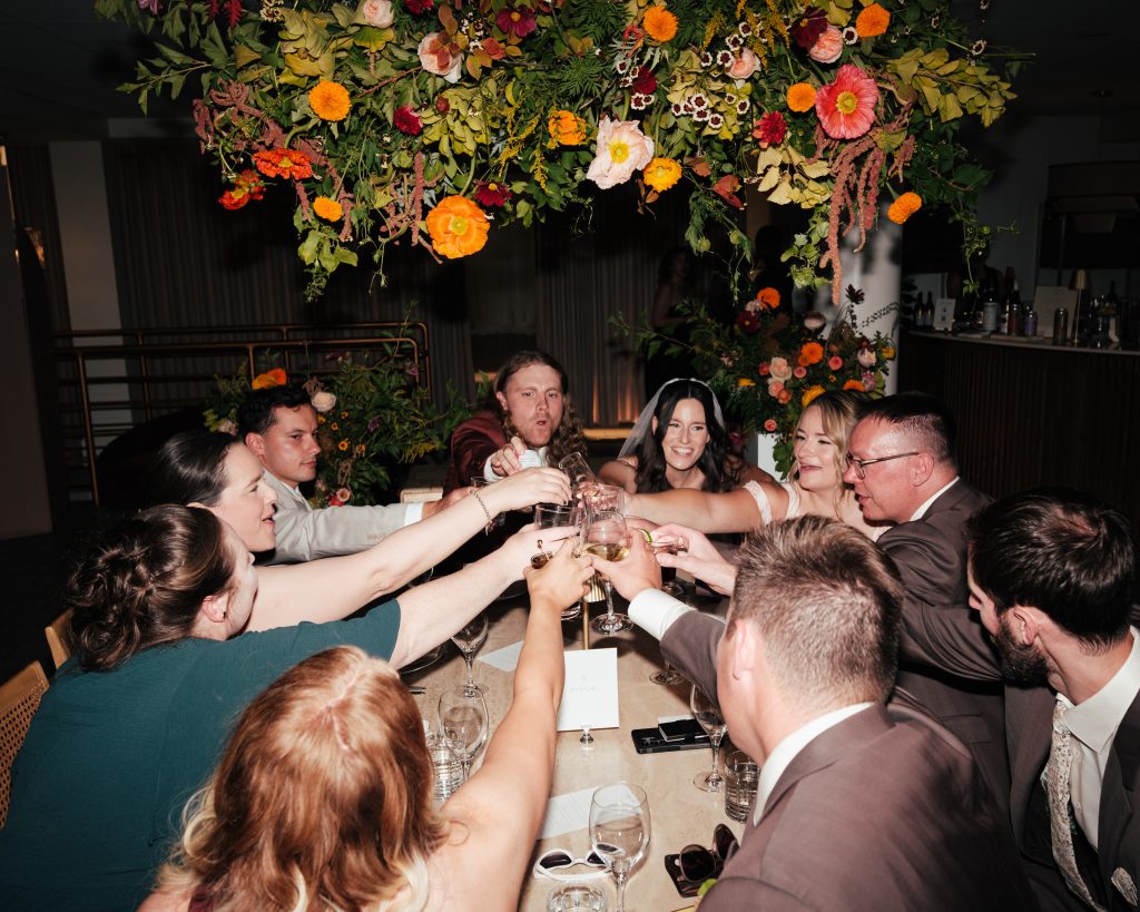 close friends and family cheers at wedding
