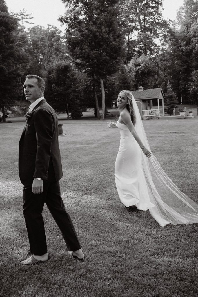 bride and groom walking around cottage